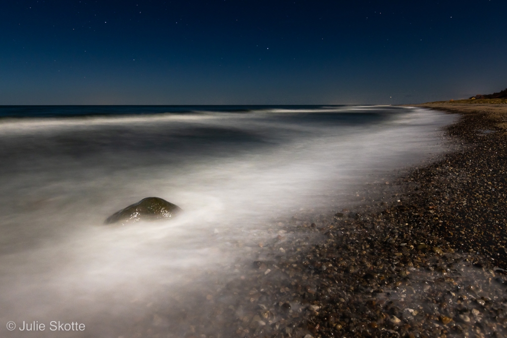 Moonlight beach and long shutter of waves crashing the shore, color version.