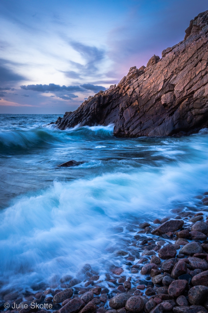 The waves are crashing against the rocks  at Josefinelyst, Kullabarg, Sweden, during windy weather.